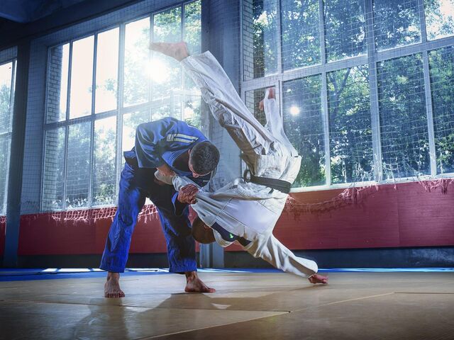 Two judo fighters showing technical skill while QCKA9 PW